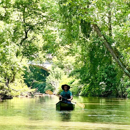 A man paddles down the Schuylkill River at Rivertribe Outdoors.