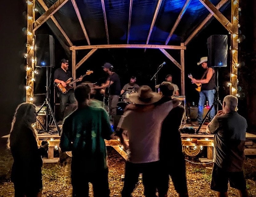 A crowd of people watching music at one of our First Saturdays' events