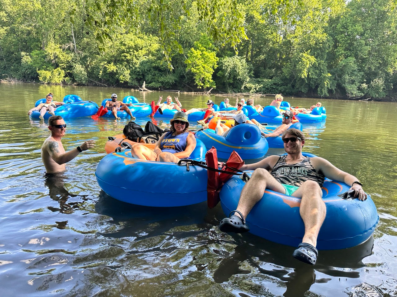 A group of people floating in tubes on the Schuylkill River.